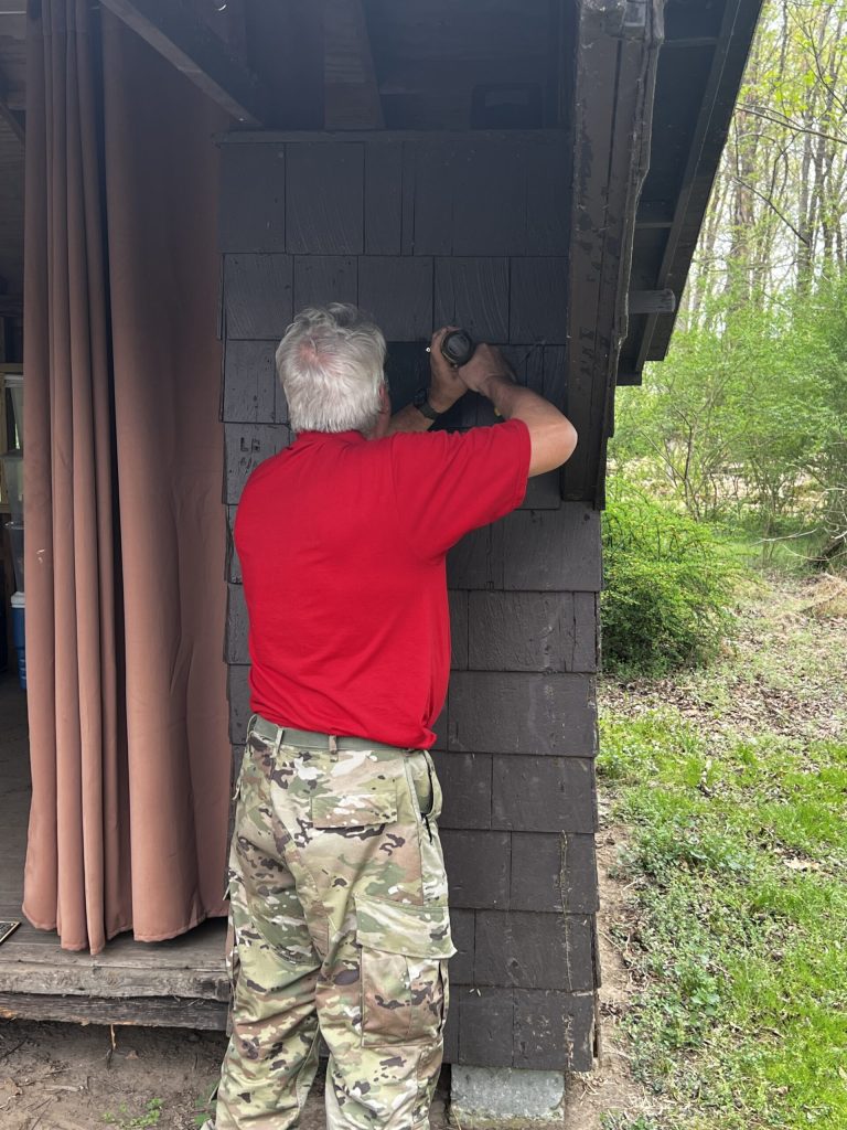 IMG_2343 - Scouting 334 Scoutmaster Dave hanging the plaque. (Photo by A. Hoppel)