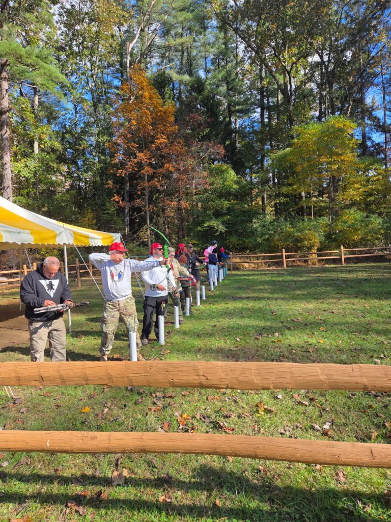 Archery! Dave aim for his balloon, Tim steals it from under him with a perfect shot.